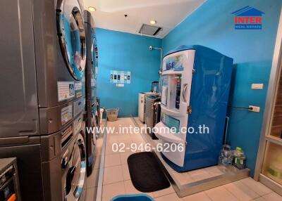 Utility room with laundry machines and vending machine