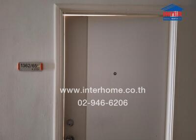 Entrance door with unit number and contact information