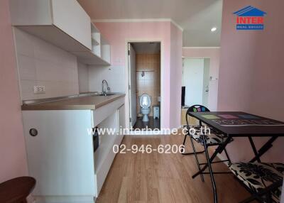 Small kitchen with dining area and a view into a bathroom