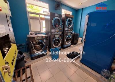 Indoor laundry room with multiple washing machines