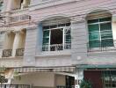 Three-story townhouse with a small front yard