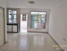 Unfurnished living room with tiled floor and large windows