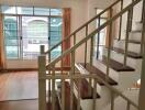 Interior living area with staircase and large window