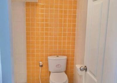 Bathroom with orange tiled wall