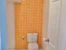 Bathroom with orange tiled wall