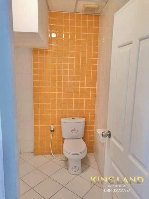 Bathroom with orange tiled wall