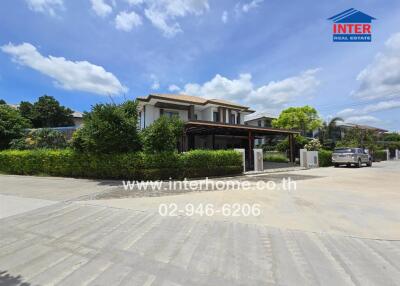 Exterior view of a property with driveway and carport