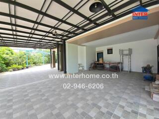 Covered outdoor area with tiled flooring and garden view