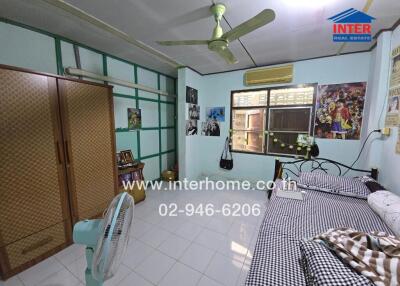 Interhome real estate bedroom with bed, wardrobe, window, fan, and wall decorations.