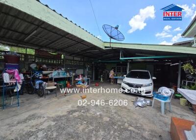 Open garage area with car and various items