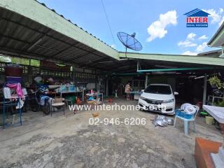 Open garage area with car and various items