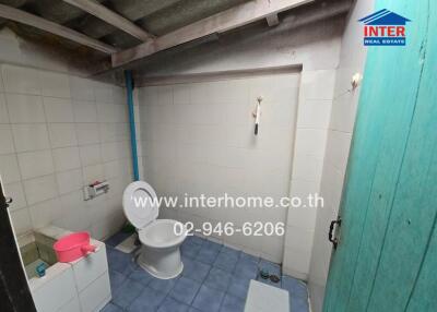 Simple bathroom with tiled walls and floor