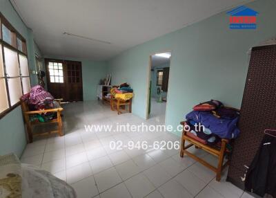 Living room with tiled floor and basic furniture