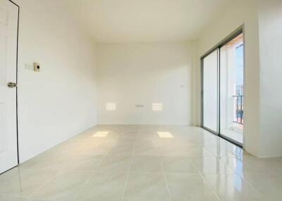 Bright, empty bedroom with sliding glass door