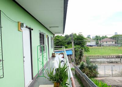 Outdoor corridor of building with greenery