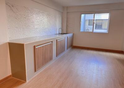 Modern kitchen with wooden cabinets and large window