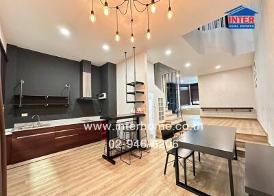 Modern kitchen and dining area with contemporary lighting