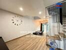 Modern living room with wooden flooring and a wall clock