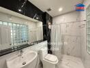 Modern bathroom with glass-enclosed shower and marble walls