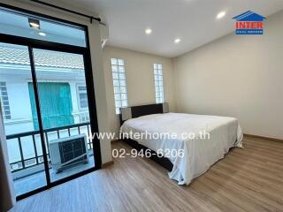 Spacious bedroom with large window and balcony access