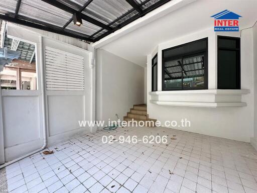 Entrance area with covered carport and window