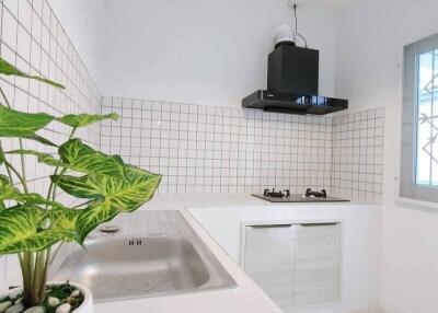 Modern kitchen with white cabinets and tiled backsplash