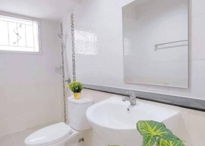 Clean and modern bathroom with sink, toilet, and mirror