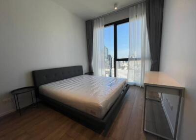 modern bedroom with large window and city view