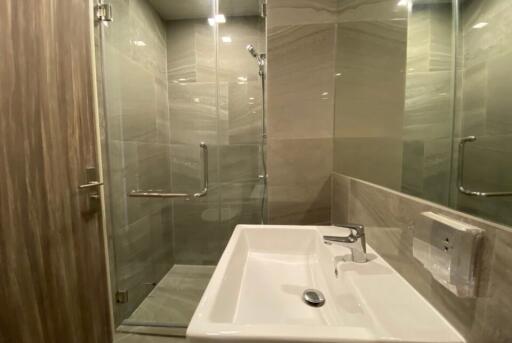 Modern bathroom with glass shower and white sink