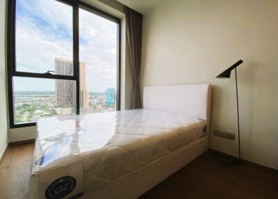 Modern bedroom with a large window and city view