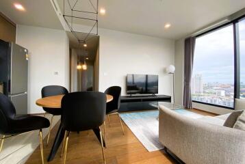 Modern living room with dining area and large window