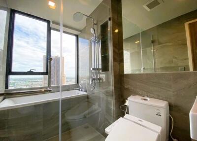 Modern bathroom with large window and city view