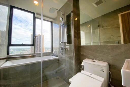 Modern bathroom with large window and city view