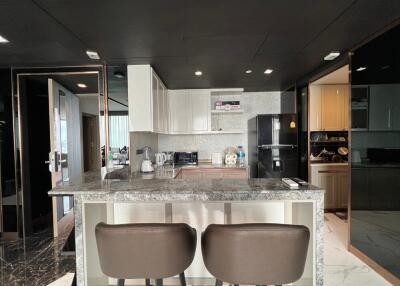 Modern kitchen with marble island and bar stools