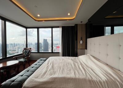 Bedroom with large windows and city view