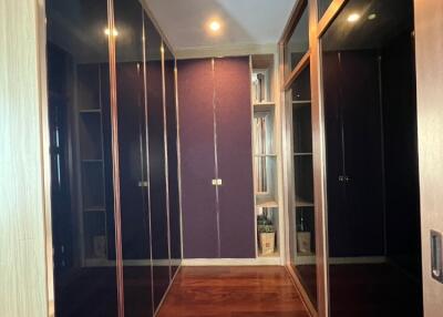 Hallway with wooden floor and mirrored closet doors