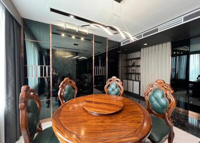 Elegant dining area with wooden table and cushioned chairs