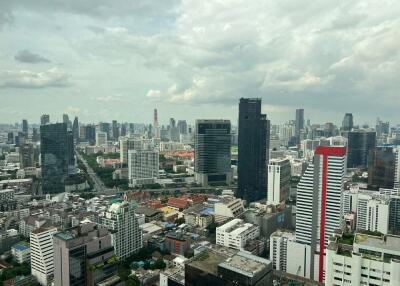 Skyline view of a city with multiple high-rise buildings under a cloudy sky