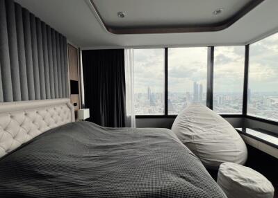 Modern bedroom with large windows and city view