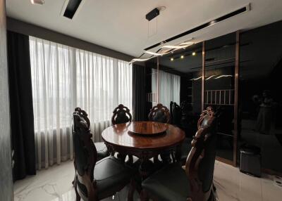 Elegant dining room with round wooden table and ornate chairs