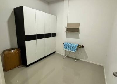 Small laundry room with a storage cabinet and ironing board