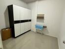 Small laundry room with a storage cabinet and ironing board