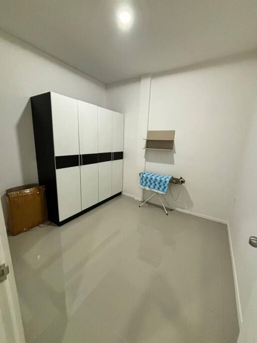 Small laundry room with a storage cabinet and ironing board