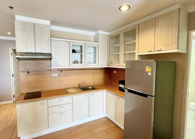 Modern kitchen with wooden cabinetry and stainless steel appliances