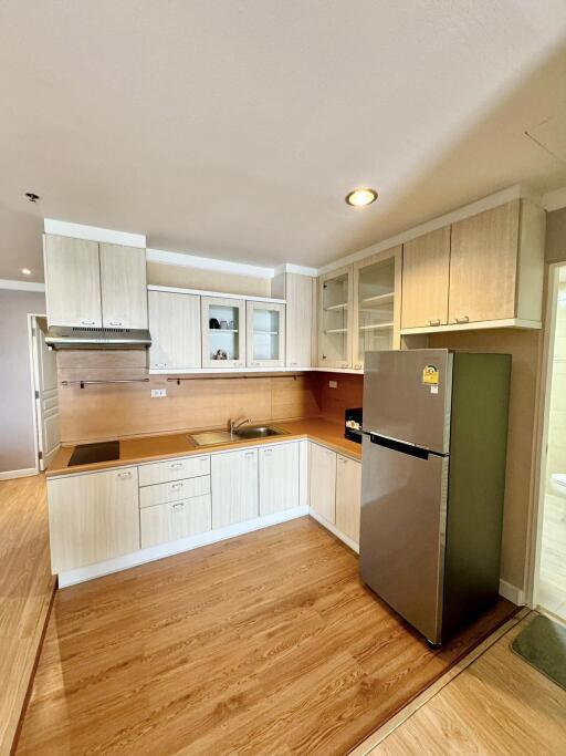 Modern kitchen with wooden cabinetry and stainless steel appliances