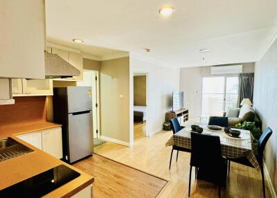 Open-plan kitchen and living area with dining table