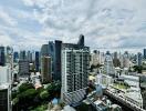 Aerial view of city with modern high-rise buildings under a partly cloudy sky