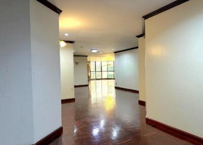 Main living area with hardwood floors, crown molding, and ample natural light