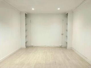 Empty room with shelves and downlights