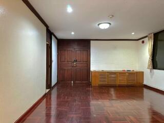 Spacious living room with wooden floor and built-in storage